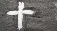 Image of cross on field of ashes