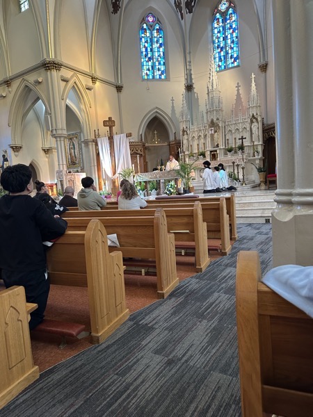 A view of the sanctuary from the pews during Mass. The church is built in a gothic style and features a rather gorgeous painted ceiling which I didn’t get any pictures of. A surprisingly large number of people present for a Saturday evening weekend Mass.