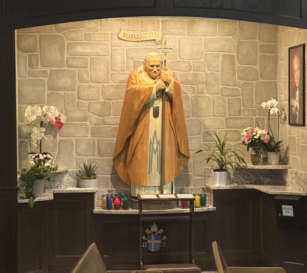 A side chapel with a statue of John Paul II at its center, a photograph of the Pope appears on the right wall of the chapel.