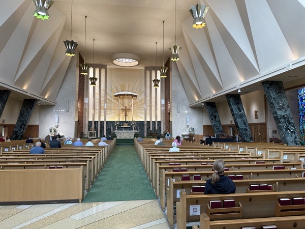 View of the sanctuary from the back of the church before Mass began. The church dates to 1953 and reflects mid-century church aestehtics.