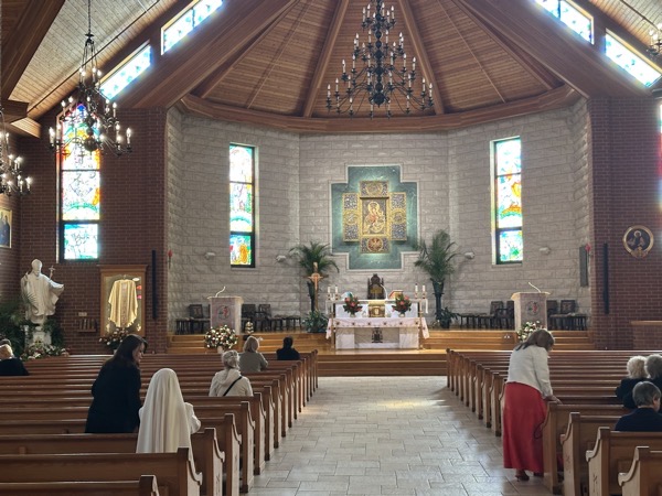 The sanctuary of Our Lady Mother of the Church with the statue of St John Paul II at the left.