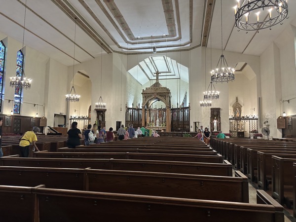 A view of the sanctuary during communion. The interior is relatively simple, although some aspects of the Tridentine sanctuary remain, with the original altar, reredos and canopy forming a major part of the sanctuary.