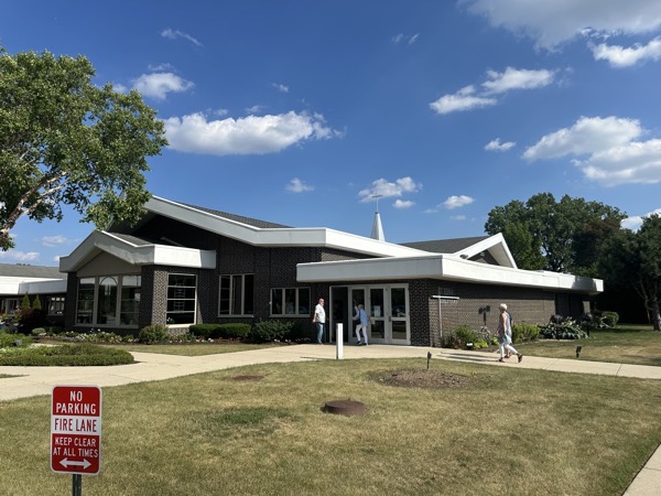 The exterior of St Edna parish, a mid-century modern-styled chruch with lots of horizontal lines and low peaks in its design