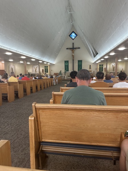 View of the sanctuary from towards the back of the church. The church decor is simple with clean modernist lines