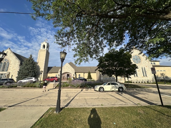 A view of Saint Anne’s church from across the street. The original church building is on the left. The bell tower and reception hall along with the new church building on the right are later additions.