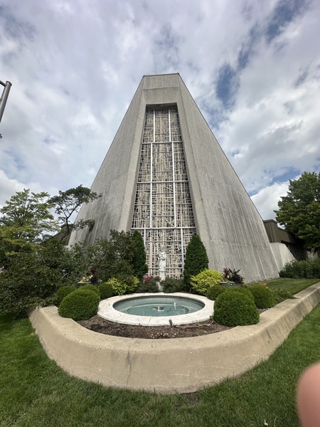 An image od the fton of the church with a fountain and statue of St Celestine before the highest point of the church,. The entrances are actually in the back.
