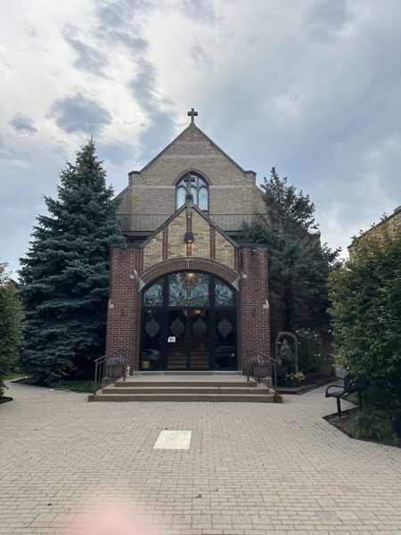 The front of the church, showing the arched entryway. The church has a high-ceilinged basement and the main worship area is up a number of steps from street level