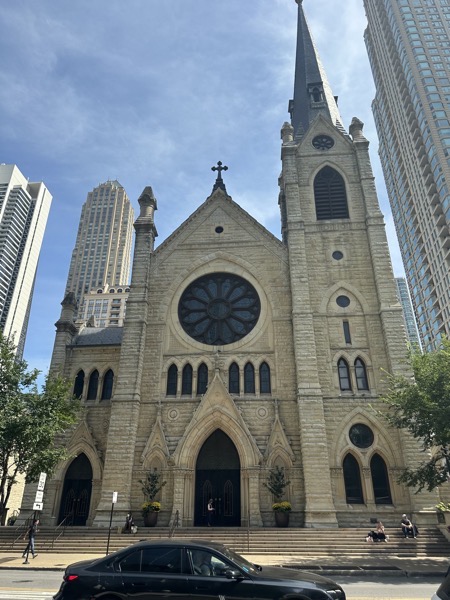 The front façade of the church as seen from State Street. The church is a neo-gothic design with a large rose window and bell tower on the left