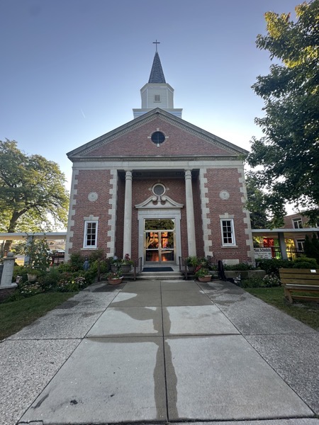 The front of the church. The style is American colonial, the sort of thing you’d expect to find in a cinematic depiction of the revolutionary war.