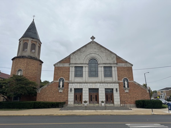 The exterior of the church, a rather blandbrick and granite façade with a belltower to the left of the church connected by a passageway. The beauty of the interior is not evident from the exterior of the church.