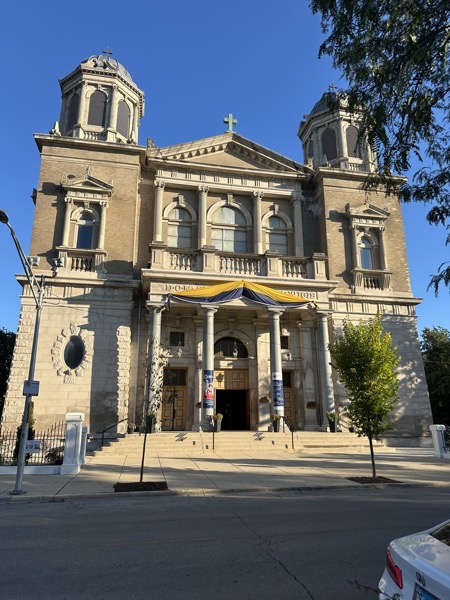The front of St Hedwig church with a pair of belltowers and a gothic façade
