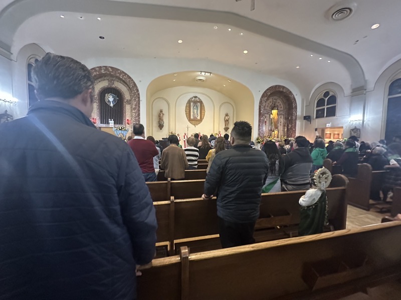 The interior of the church showing the square main area of thechurch with the sanctuary under an arch at the front of the church.