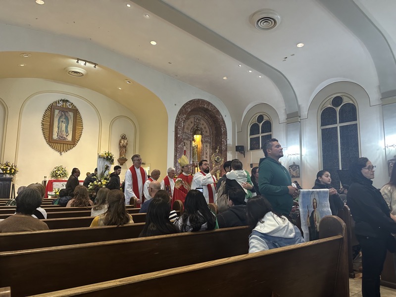 The tale end of the procession as it lined up in the church, A priest holding a reliquary is visible along with the bishop and the banner of St Jude.