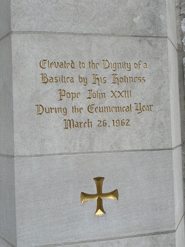 The inscription at the entrance of the church reading, “Eelvated to the Dignity of a Basilica by His Holiness Pope John XXIII During the Ecumenical Year March 26, 1962