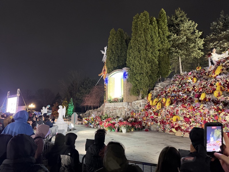 IMG_1094.jpeg The outdoor shrine area showing huge piles of flowers brought as offerings. The statue of Juan DIego is visible on the right side and in the center is the reprroduction of the cloak with the image of the virgin.