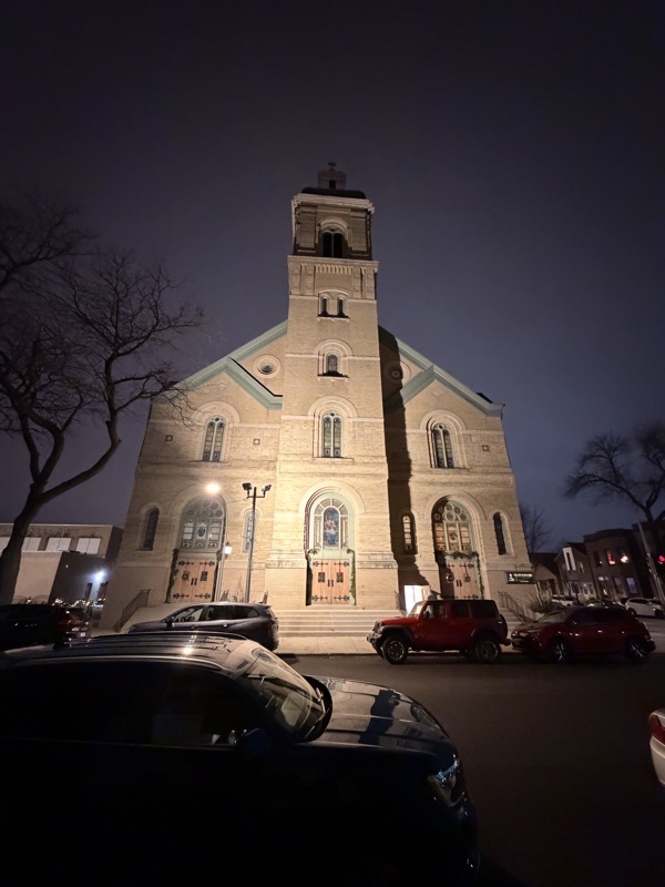 The exterior of Nativity of the Lord church lit at night for the 10p Christmas Eve service