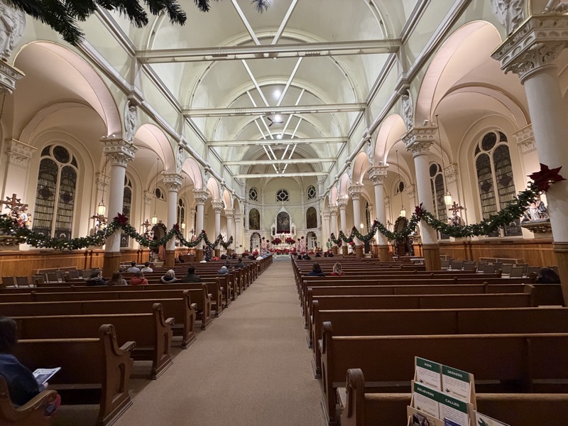 The interior of the church. It felt a lot larger than I expected it to be when I came in, probably ecause of the bright lighting. The arched roof is supprted by curved steel beamss and with spokes and crossbars. I feel like aesthetically it would have been better to have painted the beams in a contrasting color to empasize their presence rather than trying to hide them. 