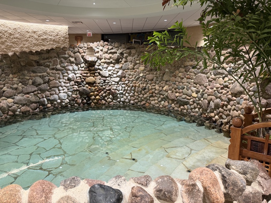 IMG_1472.jpeg The baptismal pool, which is round and about 20 feet in diameter. At it’s deepest it’s about waist deep on the deacon who waded in with the Easter candle during the litany of the saints. The far wall is a rock wall with a fountain flowing down one side. Behind that wall is the ramp leading down to the sanctuary.