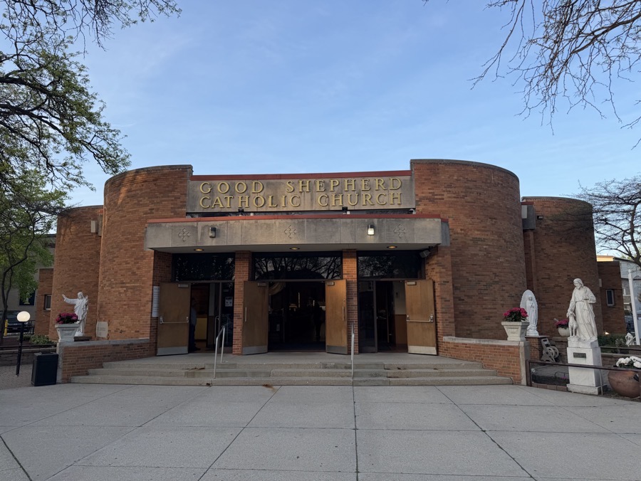 The exterior of the church, showing a brick and granite façade. The building is a low-roofed building with a flat-roof maybe 20 feet above ground level.