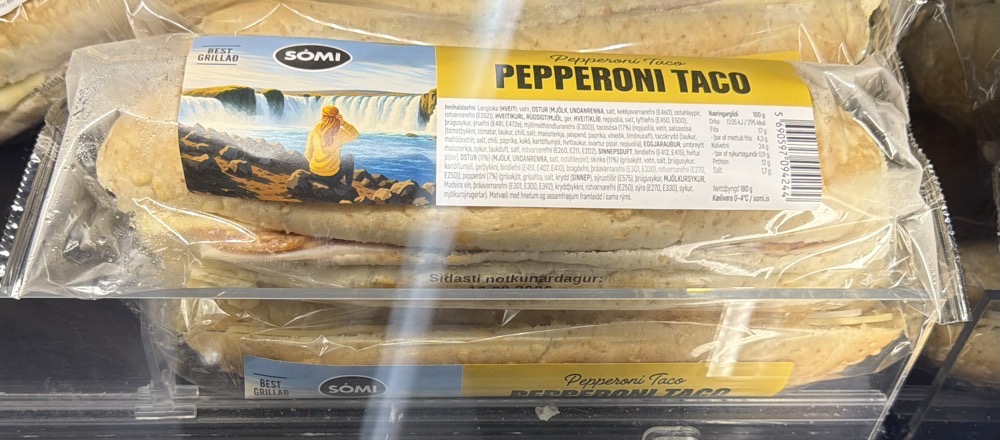 A submarine-type sandwich in a plastic wrapper offered for sale in many shops in Iceland, The label says, “Pepperoni Taco”. It is not a taco.