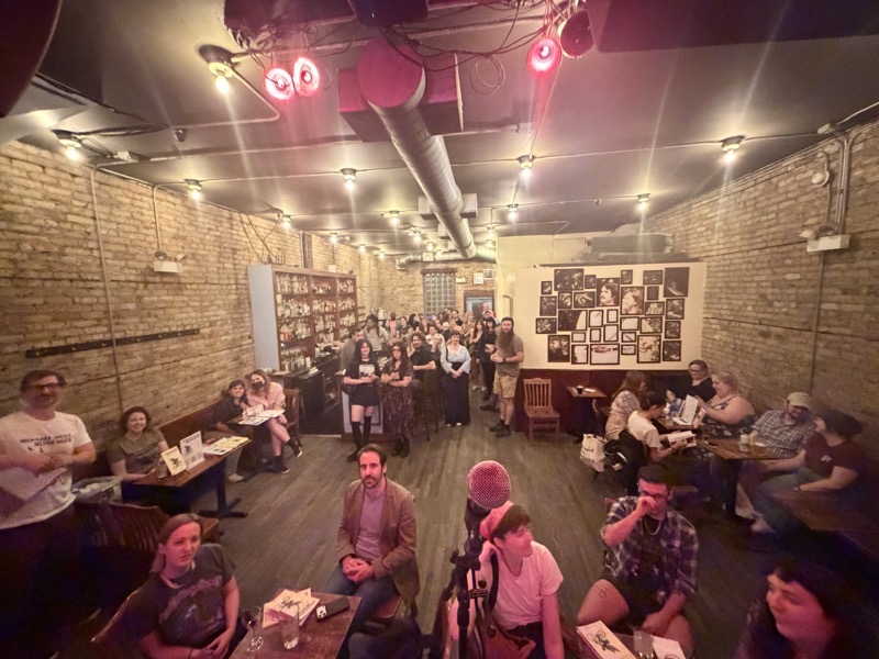 A picture of the audience  at the Whistler, a bar on Milwaukee Avenue in Logan Square. Looking at the picture, it’s apparent that it was a pretty white crowd with the only Black person in attendance working behind the bar.
